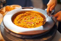 Try the paella at Restaurante Casa Benigna
