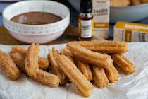 Enjoy traditional churros and chocolate at Bar El Caracol