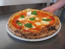 Grab a bite at Pizzeria a Tempo Perso