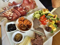 Enjoy the food and wine at Osteria Caccia al Piano