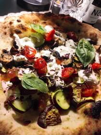 Indulge in pizza at Pizzeria Tomato and Basil