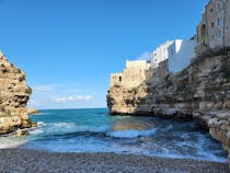 Experience the energetic beach at Grotta Piana