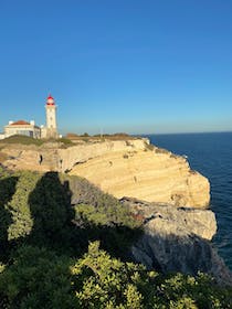 View the stunning cliffs at Farol de Alfanzina