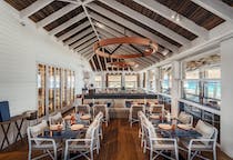 Share leisurely meals at JNcQUOI Beach Club