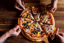Enjoy delicious pizza at Pizaza