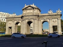 Walk under the Puerta de Alcalá