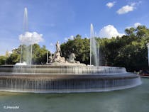 Admire classical architecture at Fuente Neptuno