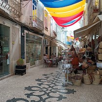 Shop for traditional Portuguese souvenirs at Largo De São Francisco