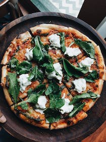 Enjoy wood-fired pizza at Pizza Remy