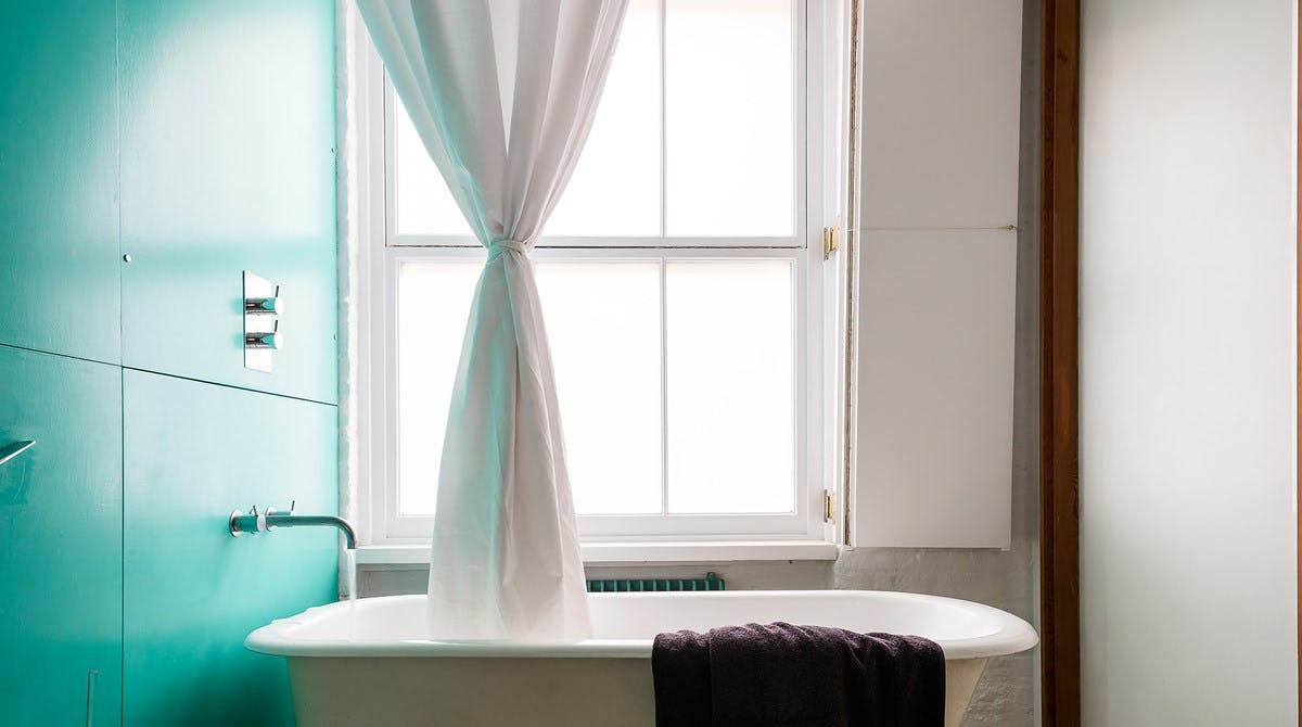 Bathroom with bath running inside Swing apartment