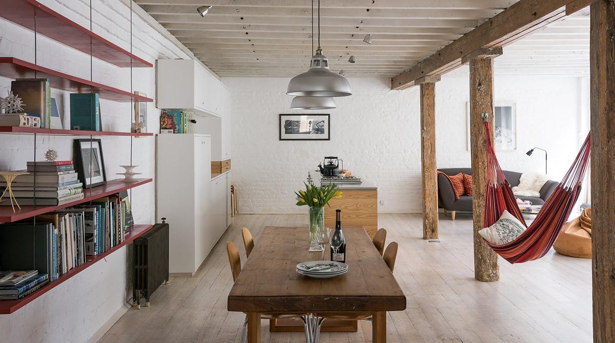 Dining area and book shelf inside Swing apartment