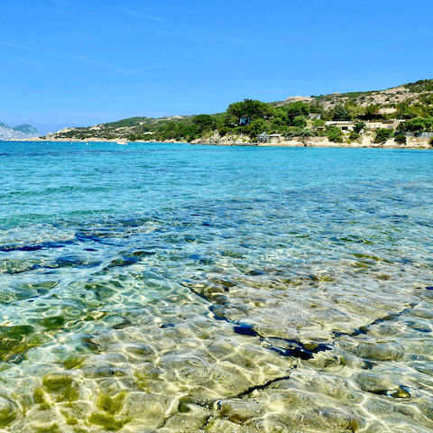 Walk just 200m to the fine white sand of Baia Caddinas