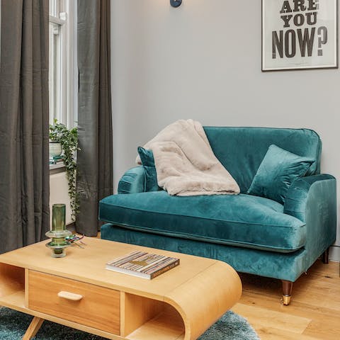 Admire mid-century touches like the plush velvet sofa