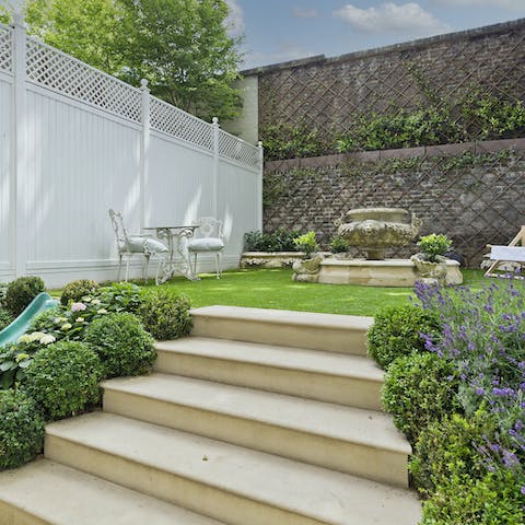 Relax with a glass of fizz in the private garden with its water feature