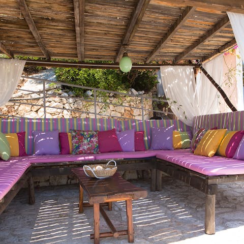 Gather on the comfy outdoor seating with drinks