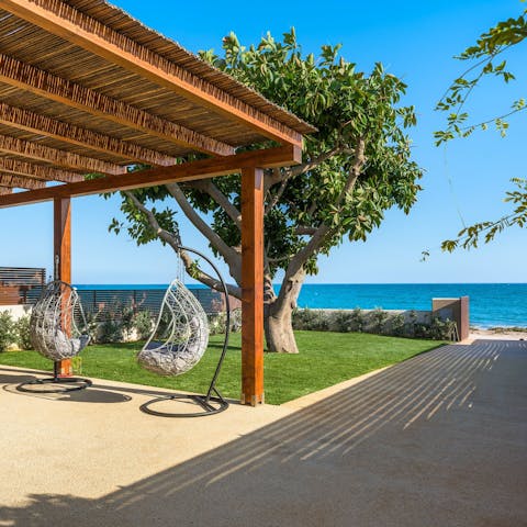 Stroll along the beach, 50m away, then unwind on the swing chairs