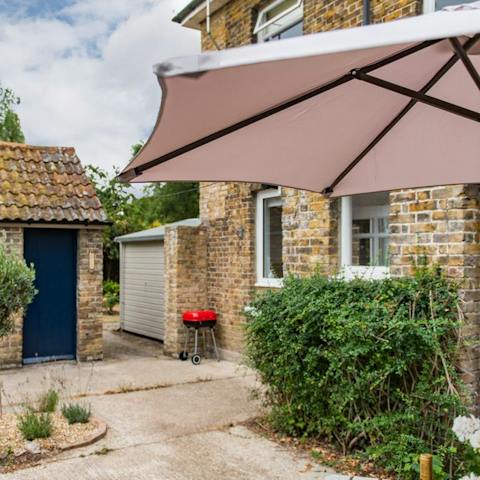 Soak up the last of the afternoon in the vast garden, enjoying wine while the barbecue works on dinner