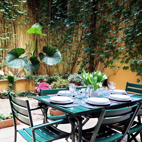 Open a bottle of wine and relax on the ivy-covered patio