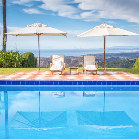 Admire far-reaching sea views from the poolside