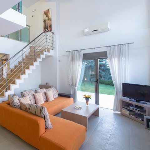 Cuddle up on sleepy evenings on your funky sofa with a movie on the TV