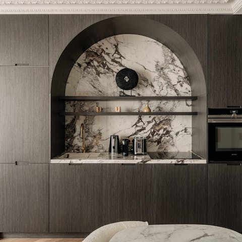 Prepare a meal in the sleek kitchen with its veined marble