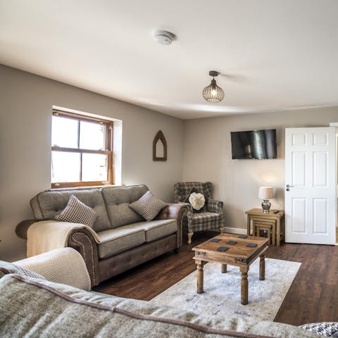 Unwind with a glass of wine in the cosy living area after a day at the beach