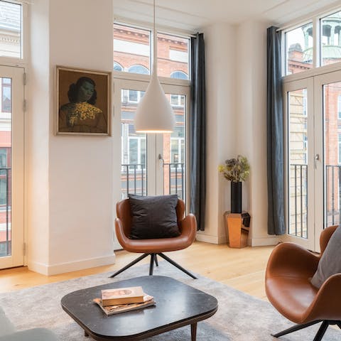 Relax in the bright living room with numerous Juliet balconies