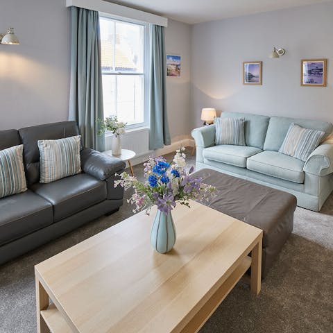 Kick back in the bright living room with a glass of wine after a day by the seaside