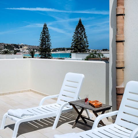 Recline on a lounger with a glass of something chilled in hand