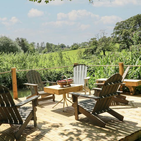 Enjoy peaceful views across the river while relaxing on the deck