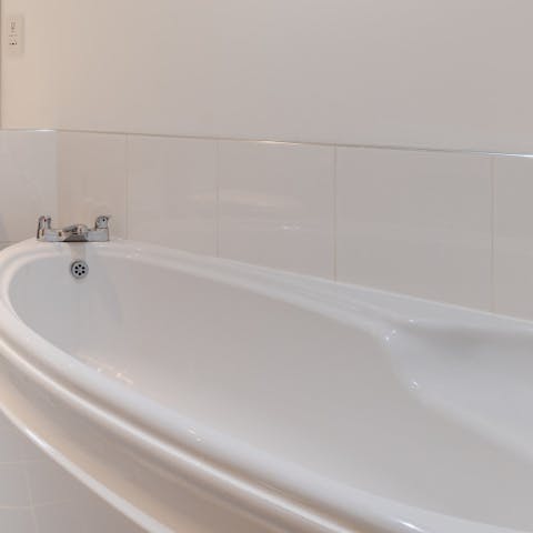 Soak in the bath tub after taking a scenic hike along the Cornish coastline