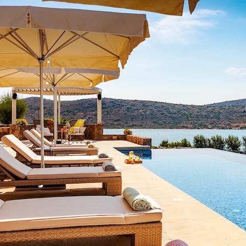 Bask in the sun by the infinity pool