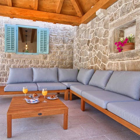 Sip cocktails together while you watch the sunset from your covered outdoor lounge area