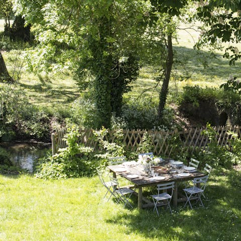 Enjoy afternoon tea under the shade of ancient oaks by the river