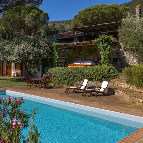 Soak up the sun by the villa's pristine pool