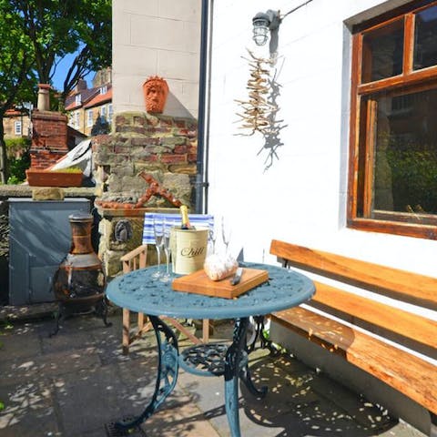 Enjoy a drink in the rustic, suntrap patio garden