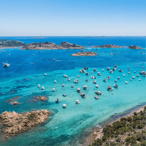 Stroll to Cala Sassari beach to swim in the clear blue sea