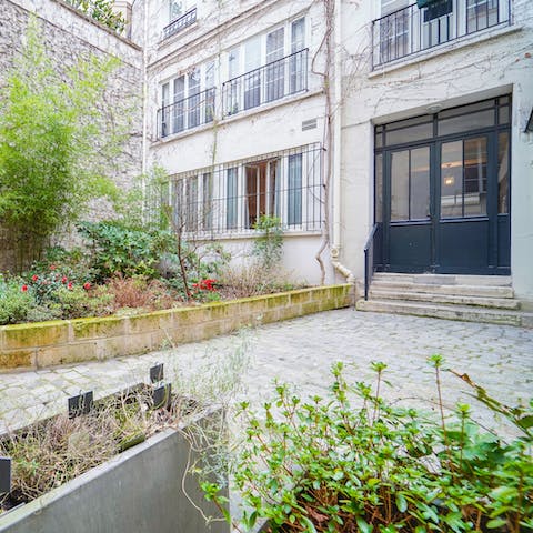 Arrive at the lush courtyard at the entrance of your home