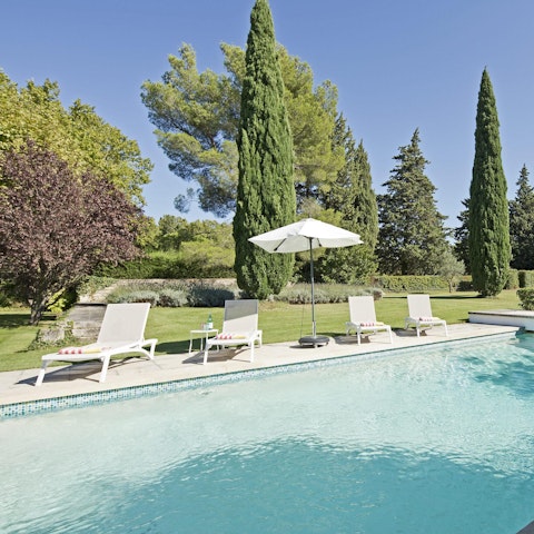 Relax on the poolside in the vast garden
