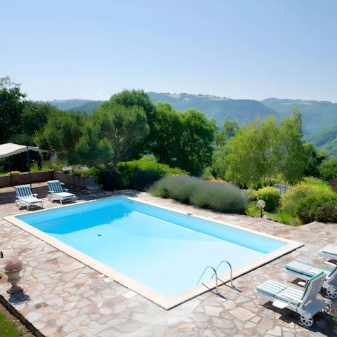 Savour the picturesque backdrop as you relax by the pool