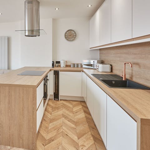 Prepare a delicious meal in the sleek kitchen, complete with a wine fridge