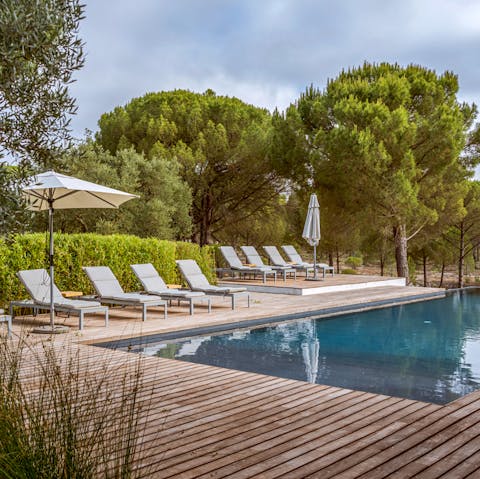 Feel the sun's warmth on your skin as you lay out poolside