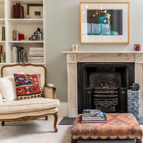 Curl up on the armchair with one of the many books from the shelves