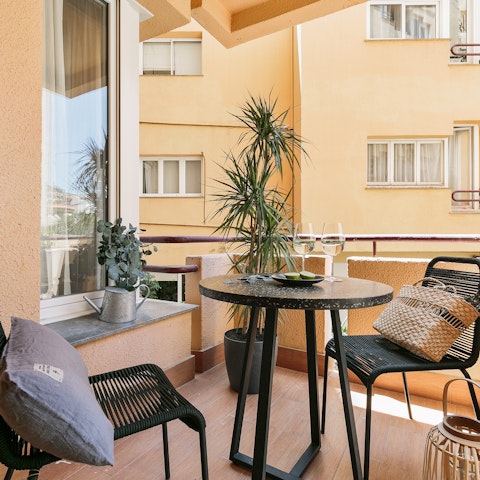 Sip a cold glass of wine on the private balcony