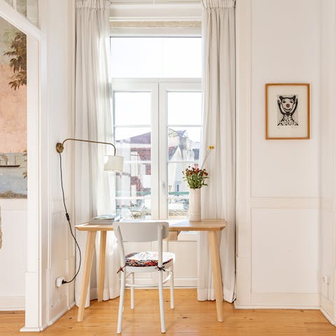 Catch up on work at the bright window-side desk