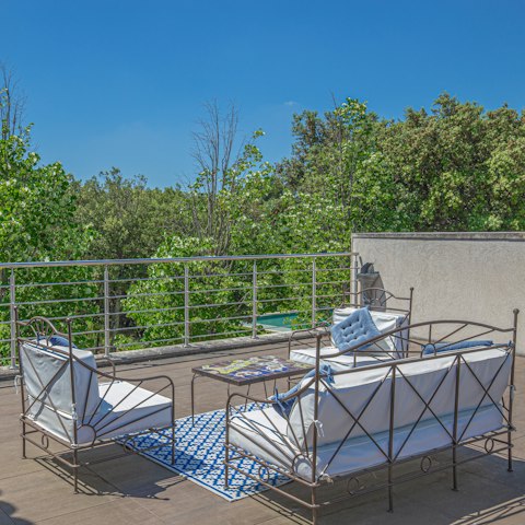 Watch the birds flit from the treetops as you sip a glass of something chilled