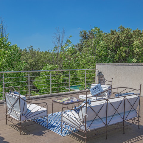Watch the birds flit from the treetops as you sip a glass of something chilled