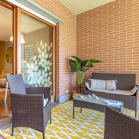 Relax with a glass of iced-coffee on the private balcony