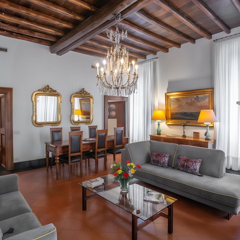 Enjoy family meals together beneath the chandelier and wood-beamed ceiling