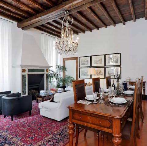 Enjoy family meals together beneath the chandelier and wood-beamed ceiling